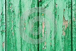 Old wooden planks with cracked peeling green paint. Painted texture background. Rustic background