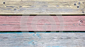 Old wooden planks painted in three colors
