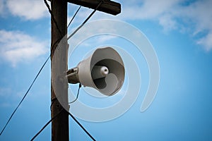On an old wooden pole, an old megaphone