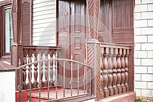 Old wooden porch. Entrance to the house. Old wooden structures. Architecture and construction. Preservation of old structures