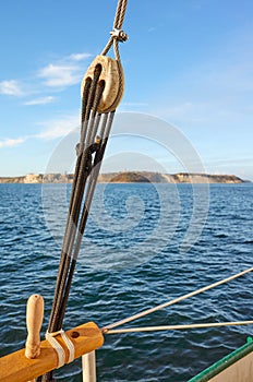 Old wooden pulley with land on horizon