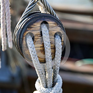 Old wooden pulley with ropes on a sailing ship