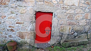 Old wooden red door in the wall