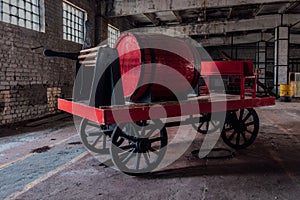 Old wooden red fire truck in abandoned building