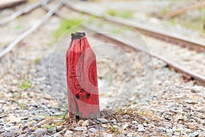 Old Wooden red pillar for warning in the split railroad