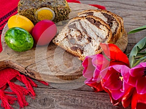 lamb tripe meat cake, sponge cake and colored easter eggs on table