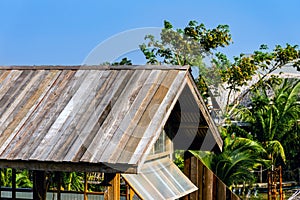 Old wooden roof tiles background. Wood background. Vintage. Wood roofing pattern detail. Old brown wooden shingle roof.View of