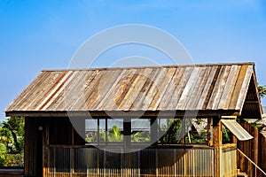 Old wooden roof tiles background. Wood background. Vintage. Wood roofing pattern detail. Old brown wooden shingle roof.View of