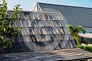 Old wooden roof tiles background. Wood background. Vintage. Wood roofing pattern detail. Old brown wooden shingle roof.View of