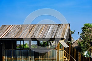 Old wooden roof tiles background. Wood background. Vintage. Wood roofing pattern detail. Old brown wooden shingle roof.View of