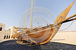 Old wooden rowing boat at historical are of Dubai. Heritage village. Boat installation