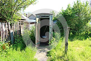 Old wooden rural toilet in summer