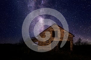 Old wooden shed under night stars