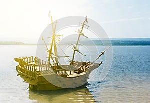 Old wooden ship with mast anchored in the sun