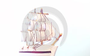 Old wooden ship with sails and masts toy on a stand. Vintage and