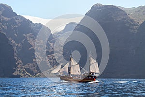 Old wooden ship with white sails