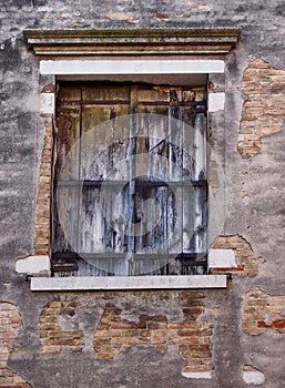 Old wooden shuttered window with faded paint