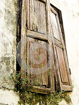 Old wooden shutters falling off hinges