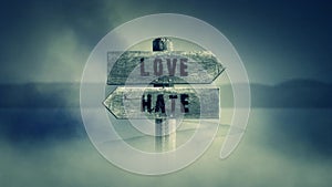 Old Wooden Sign on a Middle of a Cross Road With the Words Love or Hate