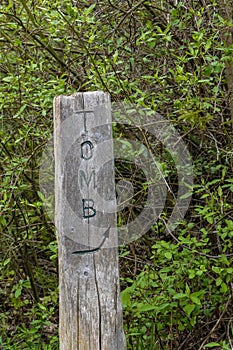 Old Wooden Sign Pointing to a Tomb photo