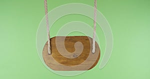 An old wooden sign swings suspended from ropes. With space for design, text place. Isolated