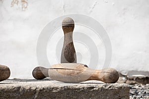 Old wooden skittles with wall on background