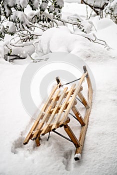 Old wooden sled in deep snow