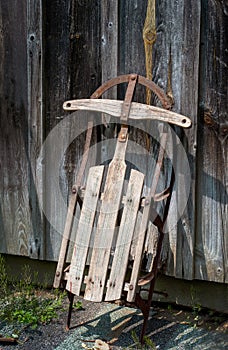 old wooden sled by wood barn