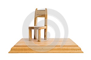 Old wooden small handmade chair on stand on isolated background.