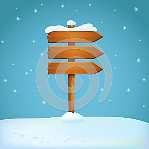 Old wooden snow covered arrow signpost on the snowy ground. Three planks pointing in the same direction.