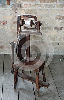 old wooden spinning wheel inside the castle tower as in the fairy tale