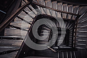 Old wooden spiral staircase without people top view. Vintage Indoor steps. golden ratio