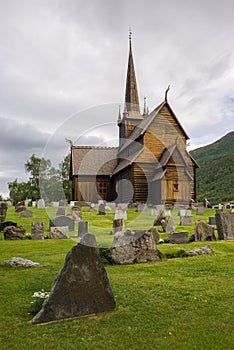 Wooden stave church with a graveyard in Lom, Norway photo