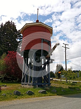 Old wooden stave water tower in The Railway Garden. Parksville, Vancouver Island. BC. Canada.