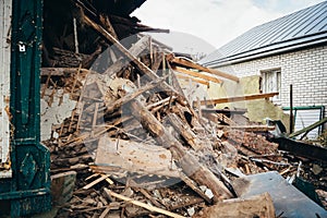 Old wooden and stone ruined building close up. Dismantling of house or after disaster