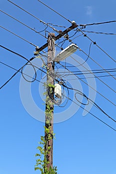 Old wooden street light pole with internet router