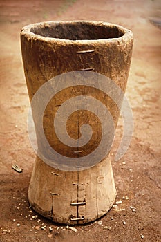 An old wooden stupa with a wooden pestle in it