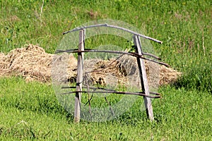 Old wooden support frame made of dry wooden boards and sticks used as support for freshly planted trees