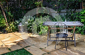 Old wooden table and black steel chair for outdoor gardens