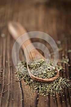Old wooden table with dried Stevia leaves (selective focus)