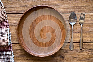 old wooden table with empty plate on a wooden table and copyspace