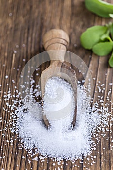 Old wooden table with Stevia Granules (selective focus)