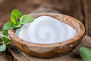 Old wooden table with Stevia Granules (selective focus)