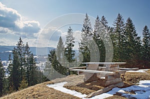 Old wooden table at top hill with spruces