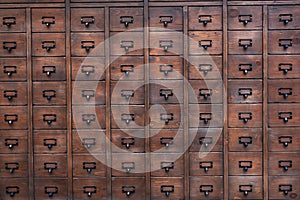 Old wooden textured drawers chest. Background of rustic wooden furniture.