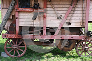 Old wooden threshing machine with flywheel and belt drive