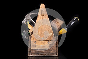 Old wooden tool box. Various DIY accessories on a workbench