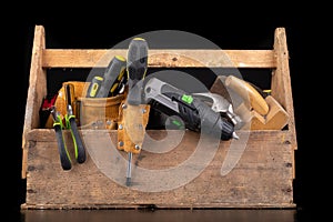Old wooden tool box. Various DIY accessories on a workbench