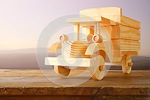 Old wooden toy car over wooden table. nostalgia and simplicity concept. vintage style image