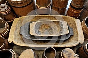 Old wooden troughs among the wooden tubs. photo